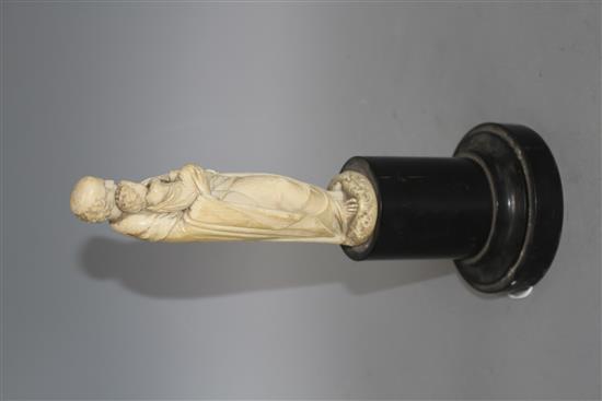 A 19th century Dieppe carved ivory figure of St Joseph holding the Christ child, 16cm, on ebony socle, overall height 26.5cm